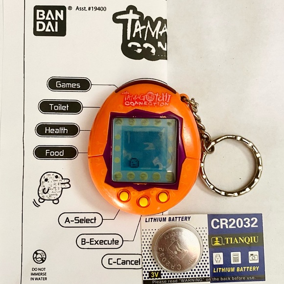 Tamagotchi Connection V1 2004 Orange w/ Purple Trim Original